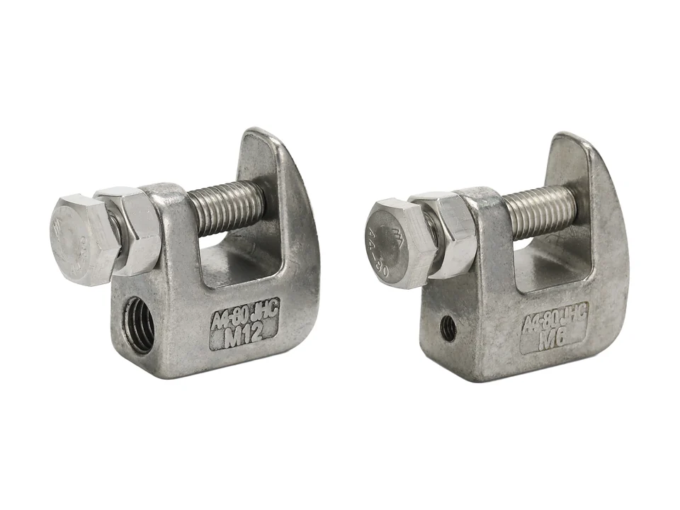 Cast beam clamps photographed with their screws and contact faces.