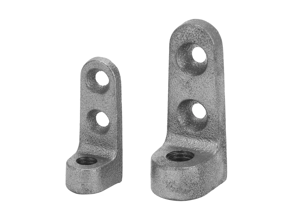 Two photographed small cast brackets with drilled holes.